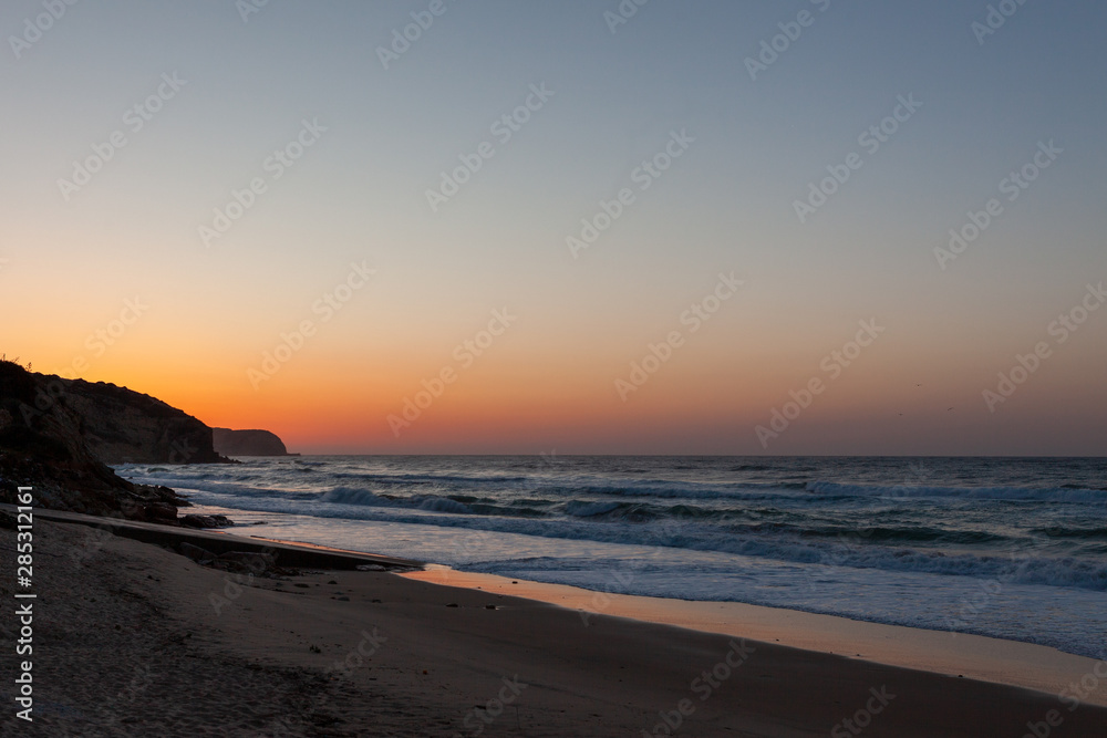 Sunset on beautiful beach at Salema, Portugal