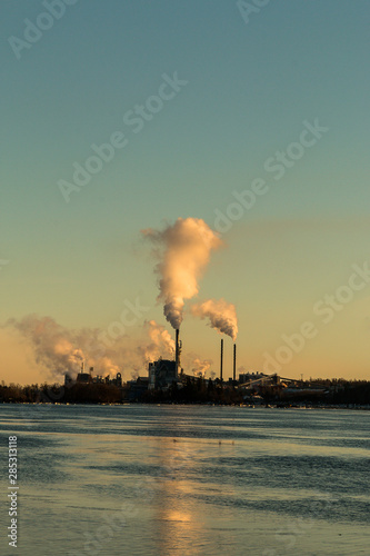 Environmental pollution concept. Pollution and smoke from chimneys of factory or power plant.