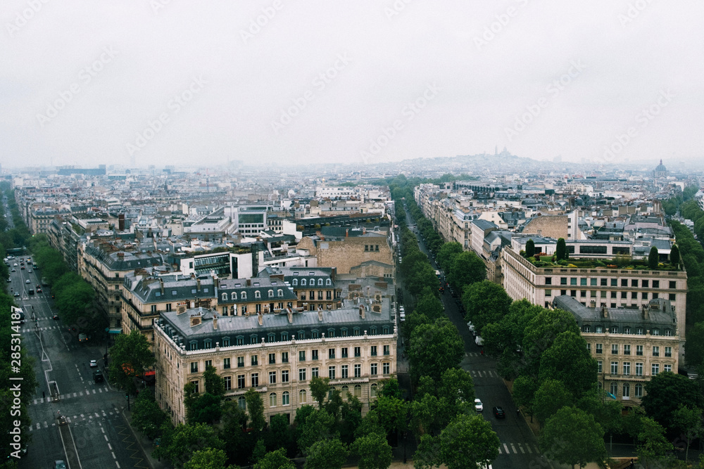 Aerial view of Paris with Sacre Coeur from the Arc de Triomphe in a cloudy day.