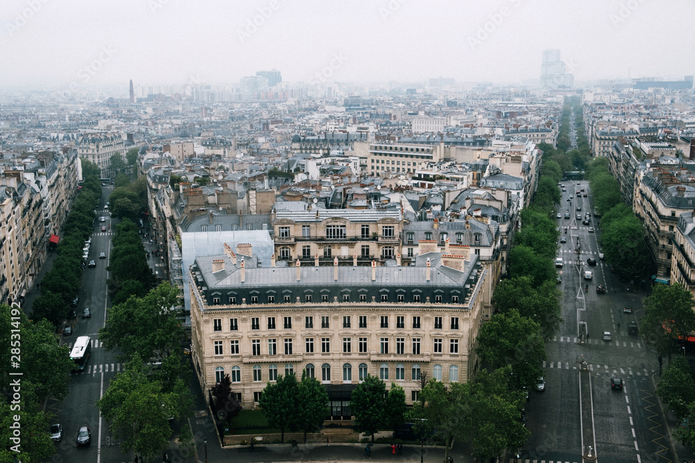 Aerial view of Paris from the Arc de Triomphe in a cloudy day. 