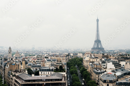 Paris view with Eiffel Tower in a foggy day. Misty romantic cityscape of Paris. 