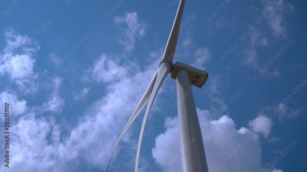 renewable energy, alteranativnye energy sources, wind turbine produces energy against the background of white clouds in the blue sky renewable energy, alteranativnye energy sources, wind turbine produces energy against the background of white clouds in the blue sky