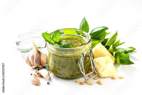 Healthy Italian cuisine. Green pesto sauce isolated on a white background.