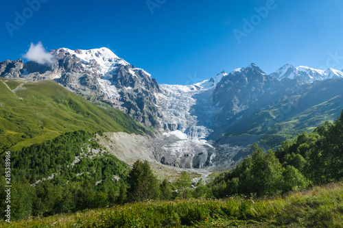 Svaneti landscape with glacier and snow-capped mountain in the back near Mestia village in Svaneti region, Georgia. © uskarp2