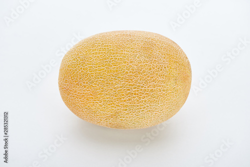 whole ripe yellow melon on white background