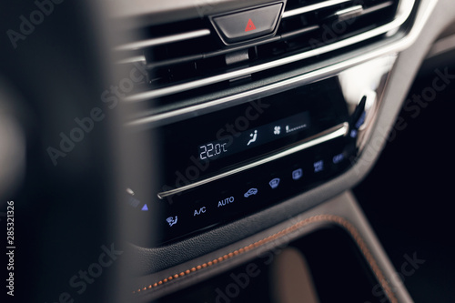 Air conditioning button inside a car. Climate control unit in the new car. Modern car interior details. Car detailing. Selective focus photo