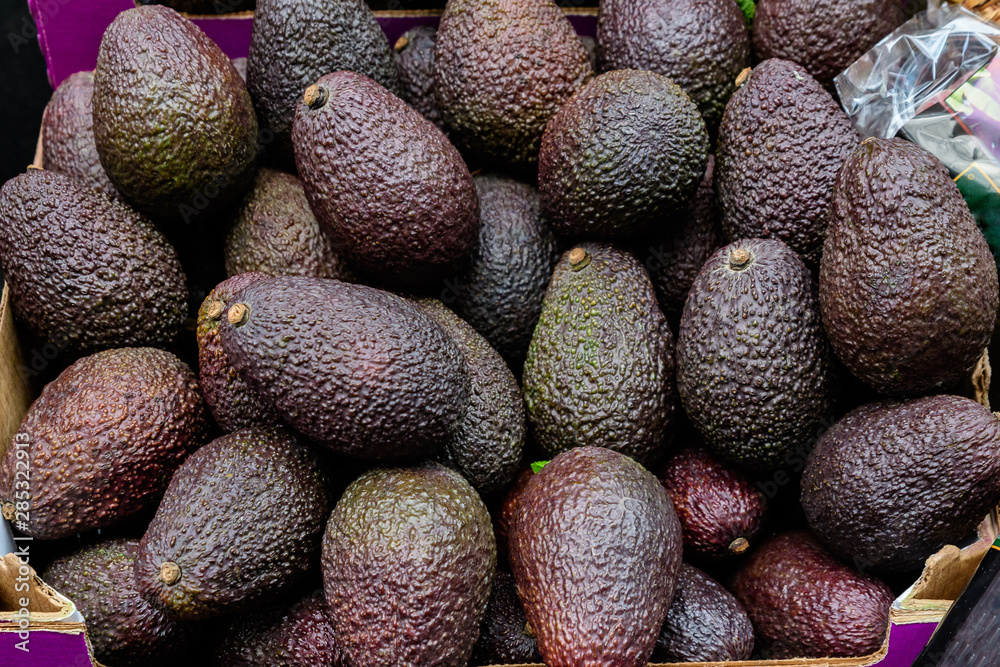 Ripe brown fresh avocado fruits in display for sale at a street food market, ready to eat Ripe brown fresh avocado fruits in display for sale at a street food market, ready to eat