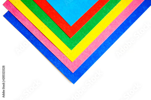 Geometric pattern from colorful sheets of cardboard on a white background. Top view