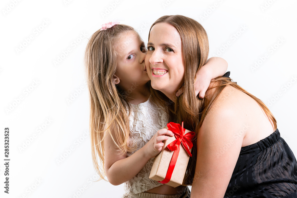 Happy Mothers Day! Child daughter congratulates mothers and giving a tight kiss on the cheek. White background, copy space. Happy Mothers Day! Child daughter congratulates mothers and giving a tight kiss on the cheek. White background, copy space.