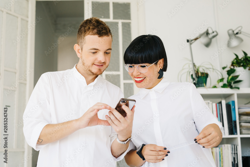 © Javier D?ez/Stocksy - Stylish man and woman working in design studio