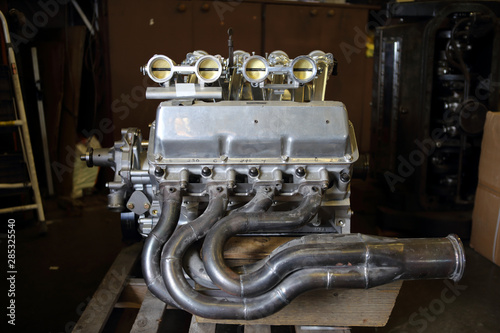 A V8 Aluminum racing engine inside a automotive garage.