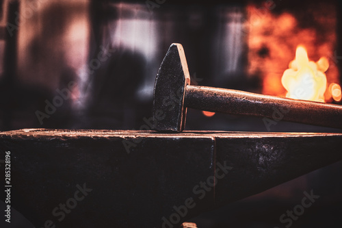 Canvas Print Close up photo shoot of hammer and anvil at dark smith workshop.