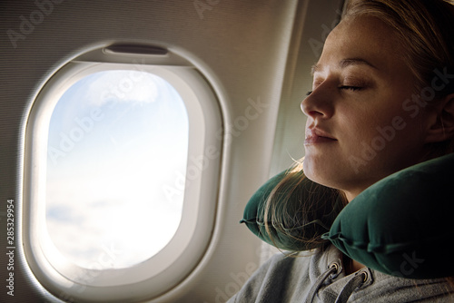 Lady peacefully sleeping in aircraft