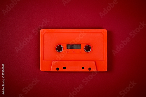 Obraz na płótnie orange audio cassette on the dark red background w salonie