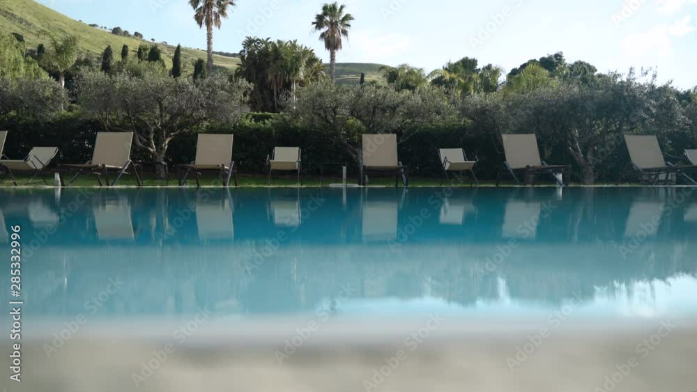 Lounge chairs by swimming pool in Sicily Lounge chairs by swimming pool in Sicily