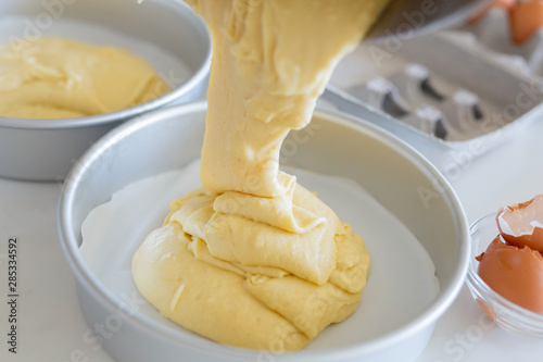 pouring vanilla batter into cake pan