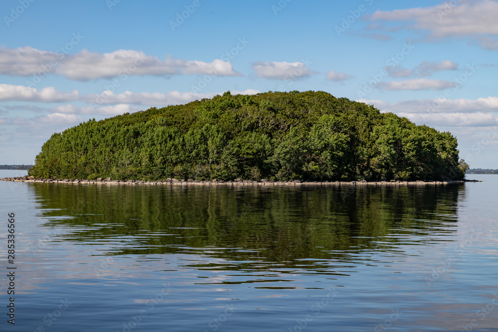 Obraz premium Island, Clouds and reflections in Lough Corrib lake