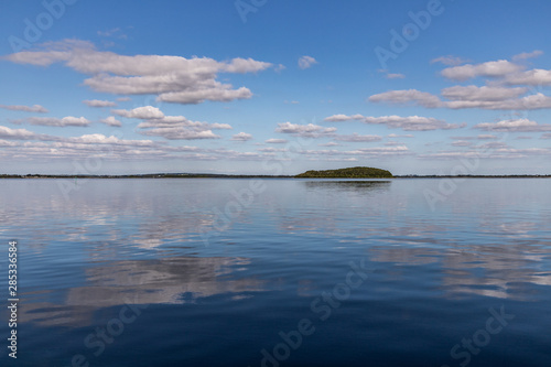 Island, Clouds and reflections in Lough Corrib lake photo