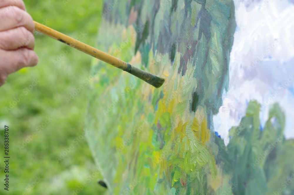 Drawing oil paintings of a natural landscape on a white cardboard Drawing oil paintings of a natural landscape on a white cardboard