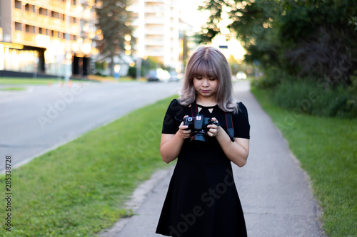 Cute Girl Photographer Checks Camera