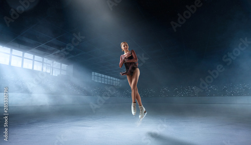 Photography Figure skating couple in professional ice arena.