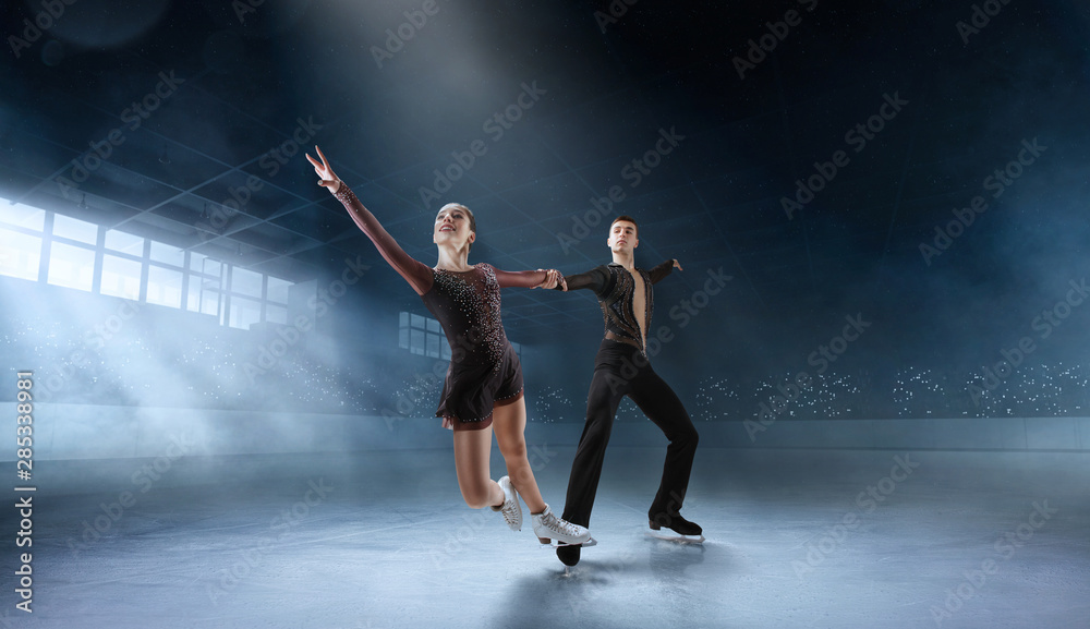 Figure skating couple in professional ice arena. Figure skating couple in professional ice arena.