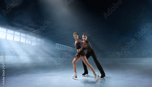 Figure skating couple in professional ice arena. © VIAR PRO studio