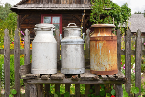 Old milk cans in The Folk Culture Museum in Osiek by the river Notec, the open-air museum presents polish folk culture. Poland, Europe