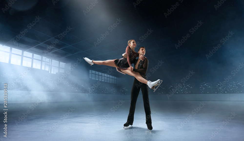 Figure skating couple in professional ice arena. Figure skating couple in professional ice arena.