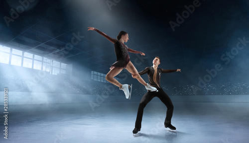 Canvas Print Figure skating couple in professional ice arena.