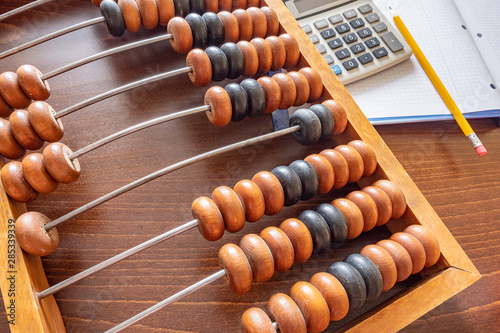 Vintage abacus, notepad, calculator and pencil.