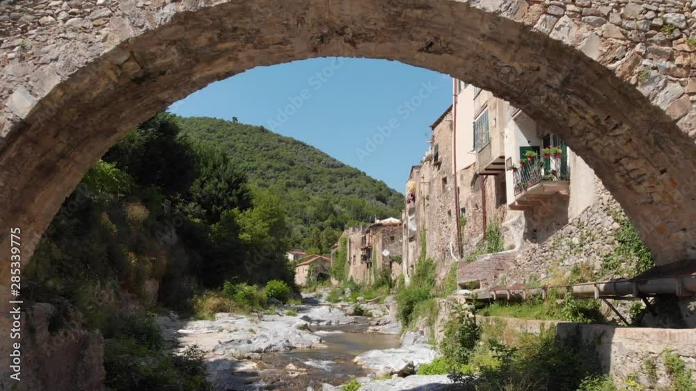 A drone flies over the small river of the medieval village of Zuccarello in Liguria, Italy A drone flies over the small river of the medieval village of Zuccarello in Liguria, Italy