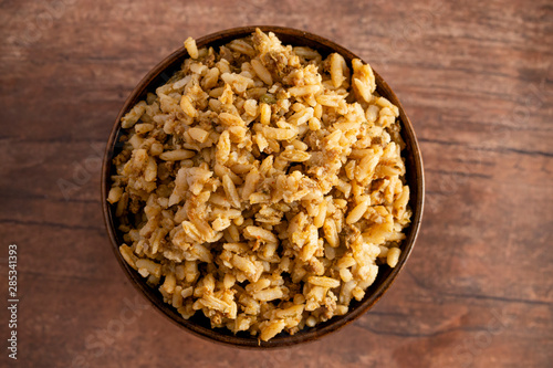 Bowl of Cajun Dirty Rice on a Rustic Wooden Table