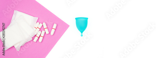 female personal hygiene products isolated on a white background blue menstrual cup and swabs pads on a pink background as a choice eco-friendly zero waste reusable product for a period of time