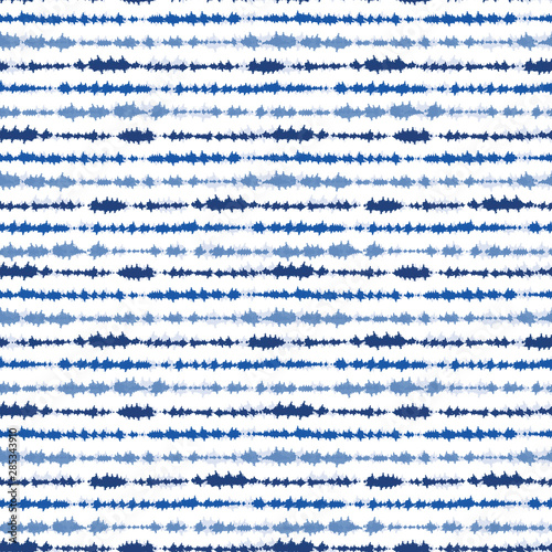 Indigo blue shibori tie dye horizontal stripe. Seamless pattern background. Japanese style batik textile. Variegated for summer fashion swatch. photo