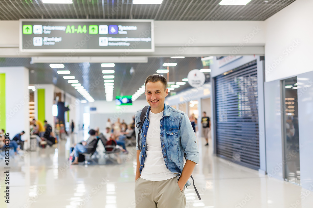 portrait of a happy male traveler walking with backpack portrait of a happy male traveler walking with backpack