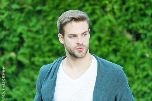 Man knows what real beauty is. Handsome man unshaven face and stylish blond hair. Handsome caucasian man nature green background. Bearded guy casual style. Simplicity, good taste and grooming