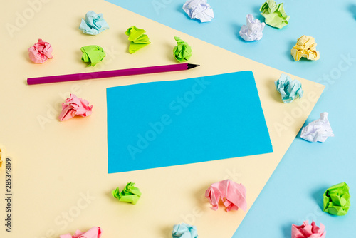 Colored crumpled papers empty reminder blue yellow background clothespin