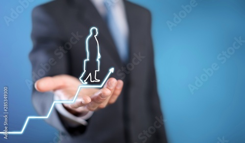 Businessman holding digital glowing graph with silhouette