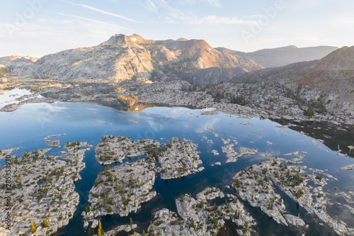 The Sierra Nevada mountains in California are made up of 100 million year old granite that were sculpted by glaciers. Snowmelt now forms many lakes throughout the dramatic mountain range.
