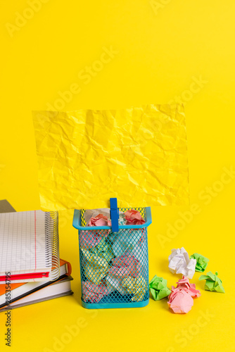 Trash bin crumpled paper clothespin empty reminder office supplies yellow