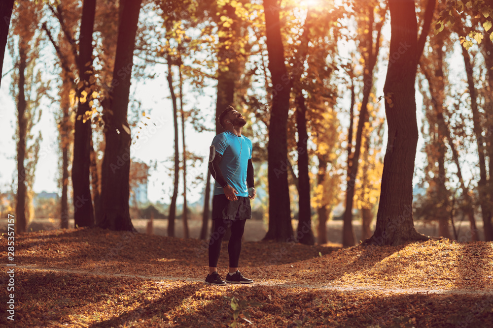 Handsome man running in the forest. Handsome man running in the forest.