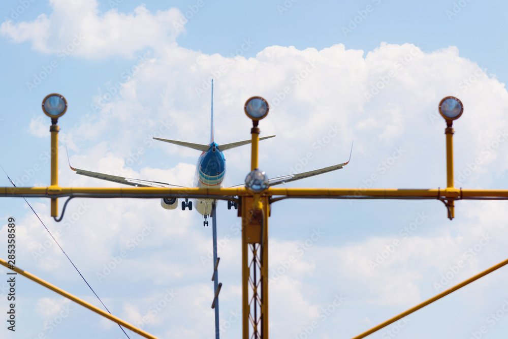 Passenger airplane landing in the airport runway. Passenger plane and blue sky with clouds. Details of airplane landing . Passenger airplane landing in the airport runway. Passenger plane and blue sky with clouds. Details of airplane landing .