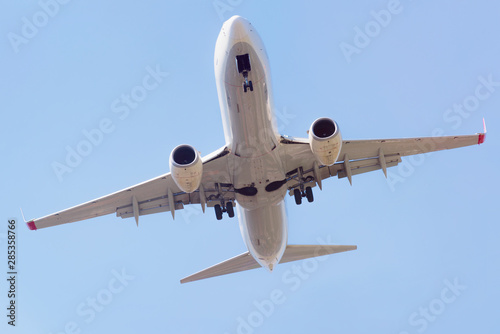 Passenger airplane landing in the airport runway. Passenger plane and blue sky with clouds. Details of airplane landing .