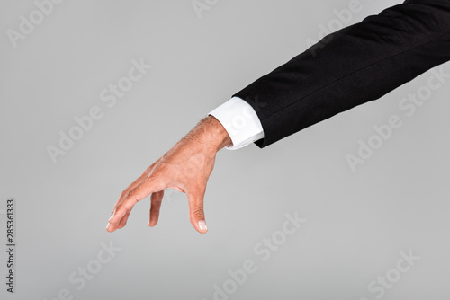 cropped view of businessman hand gesturing isolated on grey