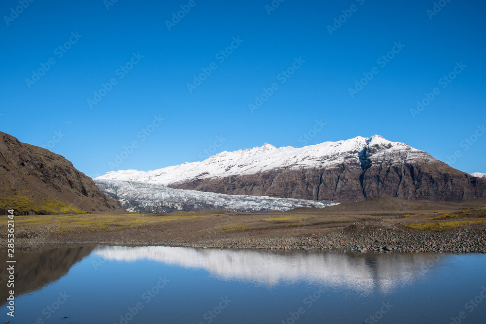 River Holmsa, Glacier Flaajokull and mountain and Flafjall mountain on a summer day in south Iceland