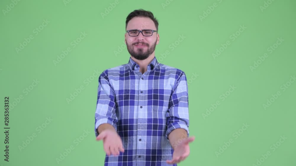 Happy young bearded hipster man looking surprised Happy young bearded hipster man looking surprised