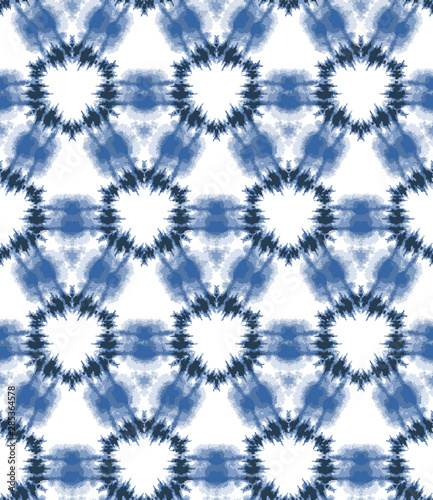 Indigo blue shibori tie dye sunburst circle background. Seamless pattern grid on white background. Japanese style batik textile. Variegated for summer fashion swatch.