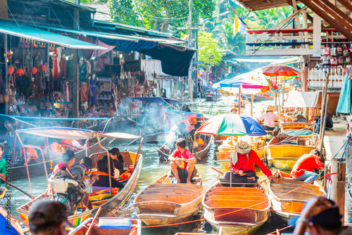 Damnoen Saduak Floating Market, tourists visiting by boat, located in Bangkok, Thailand.