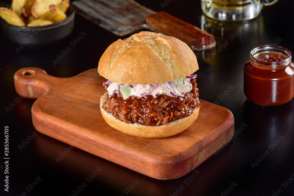 Pulled pork sandwich on rustic decorated scene Pulled pork sandwich on rustic decorated scene